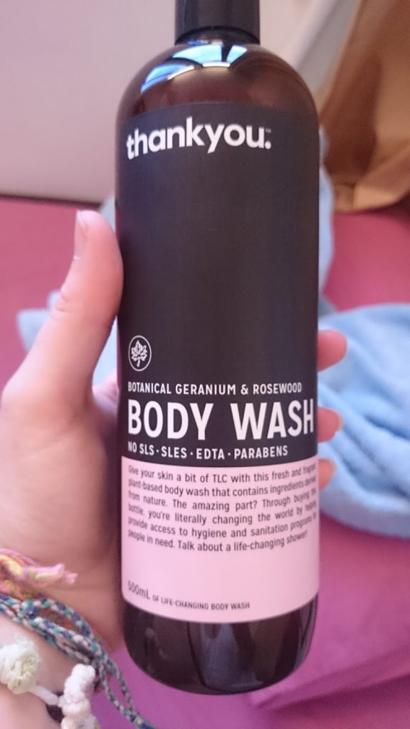 hand-holding-bottle-of-thank-you-body-wash