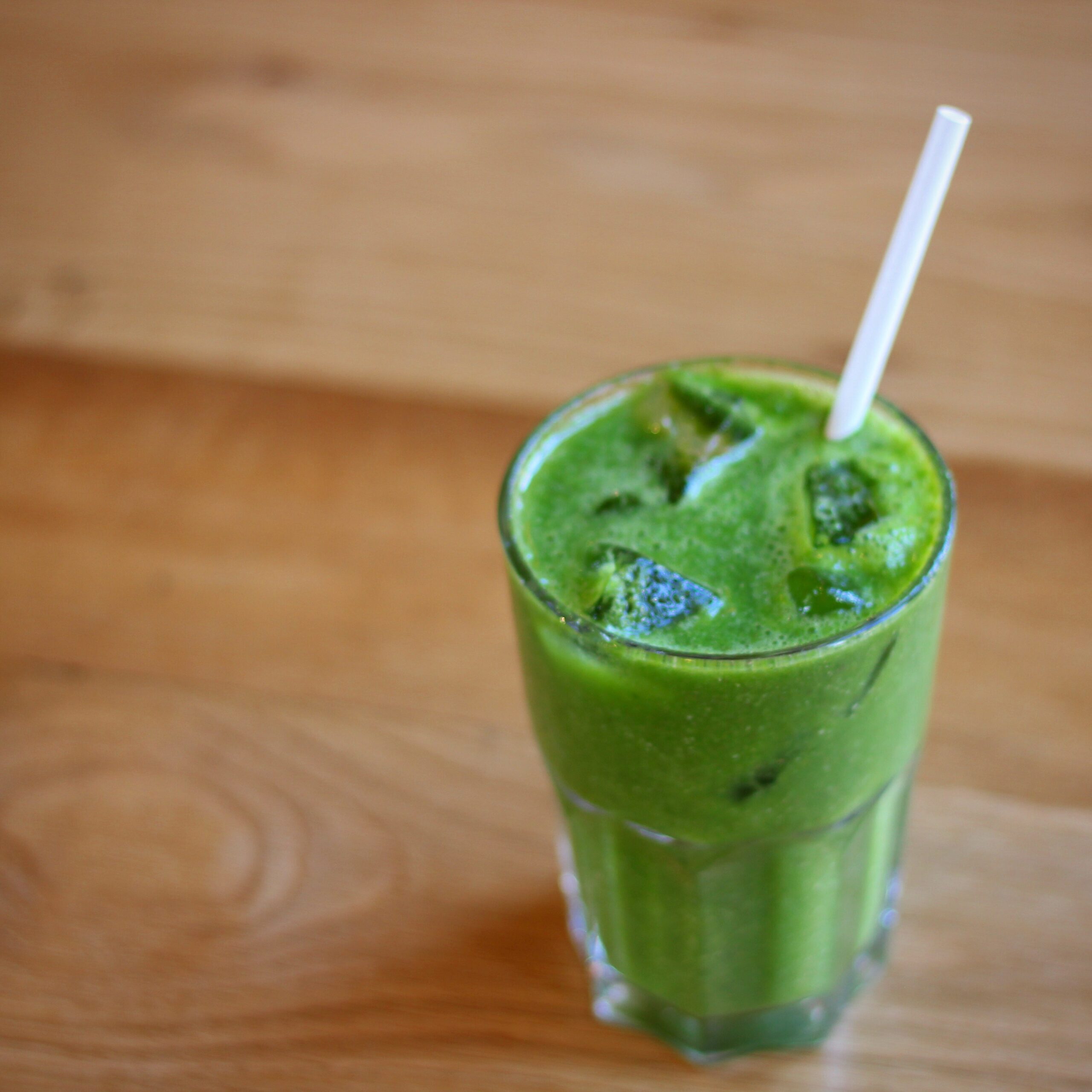 glass-of-green-smoothie-with-ice-and-straw-from-Boston Tea Party