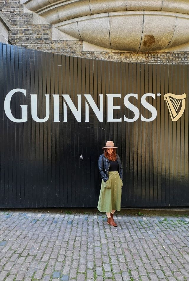 Girl standing in front of Guinness Storehouse gates