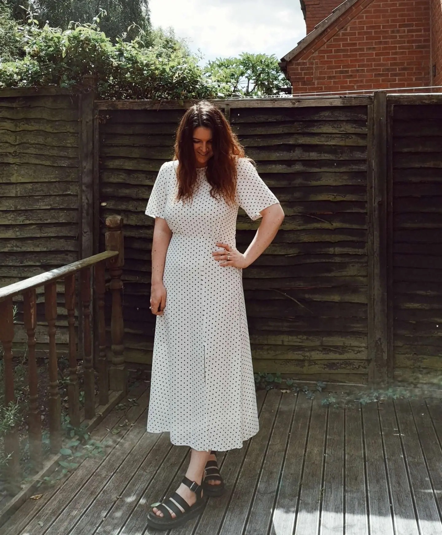 Woman standing in polkadot dress in garden